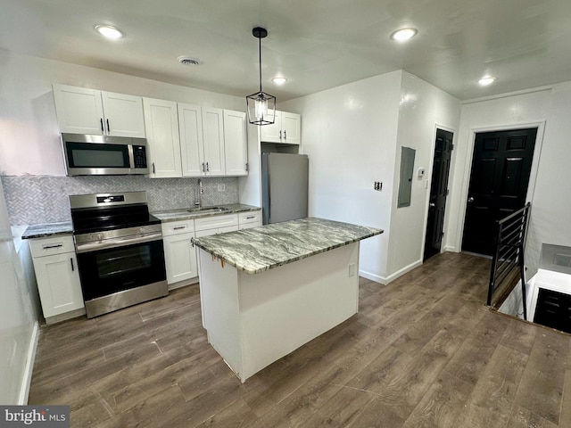 kitchen featuring stainless steel appliances and white cabinets