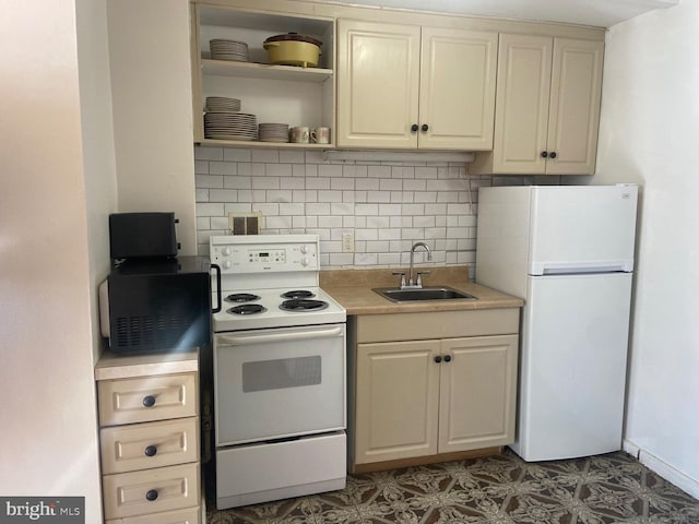 kitchen with cream cabinets, white appliances, tasteful backsplash, and sink