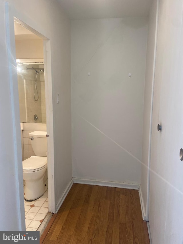 bathroom with wood-type flooring and toilet