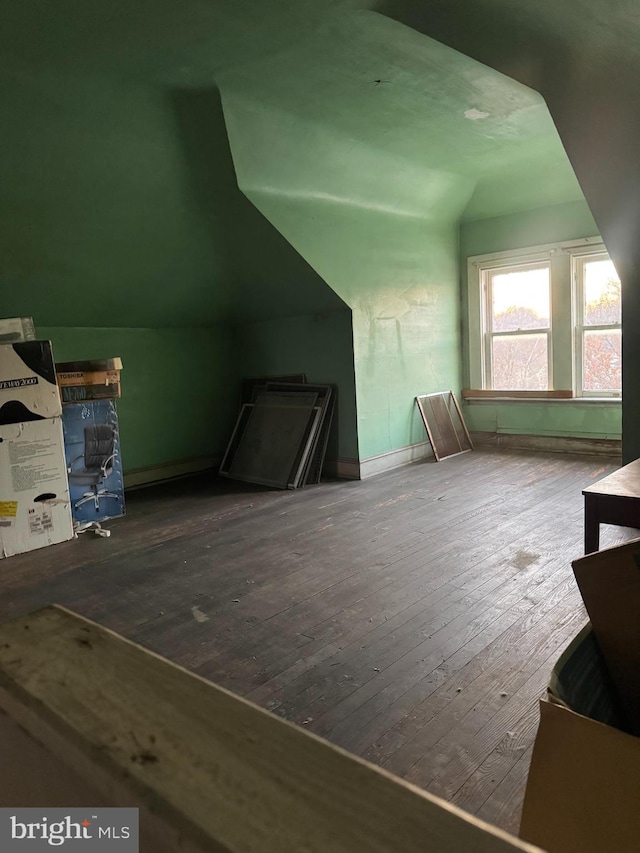 bonus room with lofted ceiling and wood-type flooring