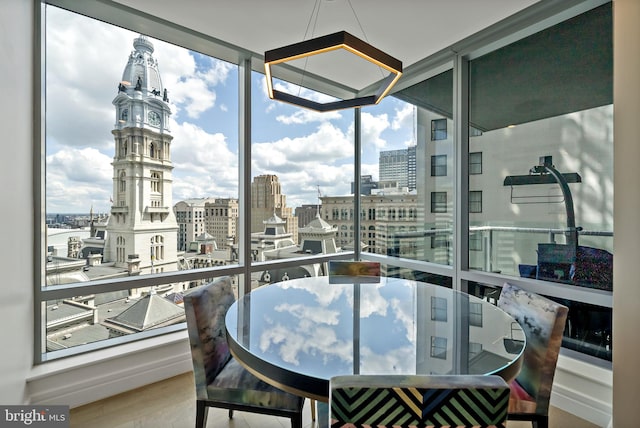 interior space with hardwood / wood-style floors, plenty of natural light, and floor to ceiling windows