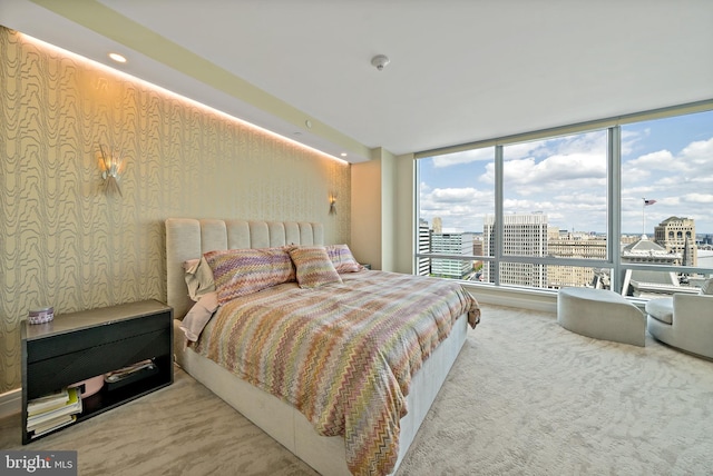 bedroom featuring floor to ceiling windows and carpet floors