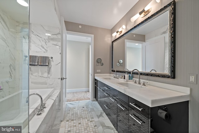 bathroom with vanity and tiled tub