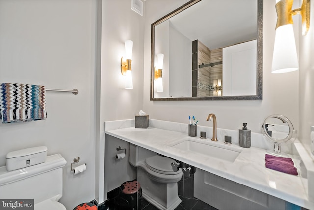 bathroom featuring tile patterned floors, a shower, vanity, and toilet