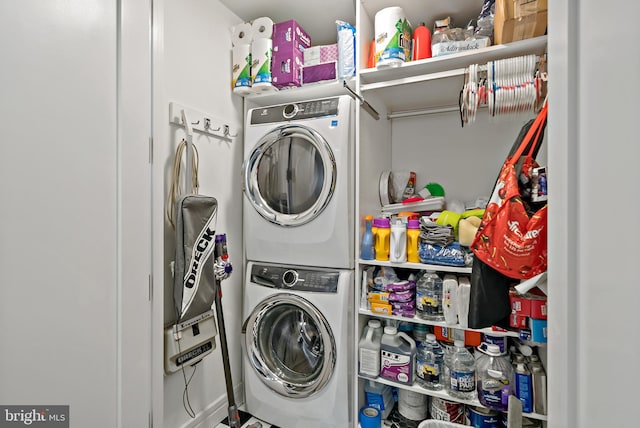 washroom with stacked washing maching and dryer