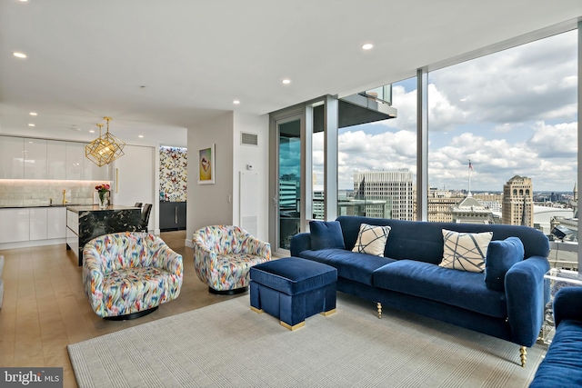 living room with light hardwood / wood-style floors and floor to ceiling windows