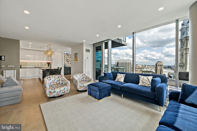 living room with expansive windows and light wood-type flooring