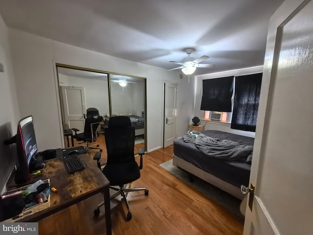 bedroom with hardwood / wood-style floors and ceiling fan