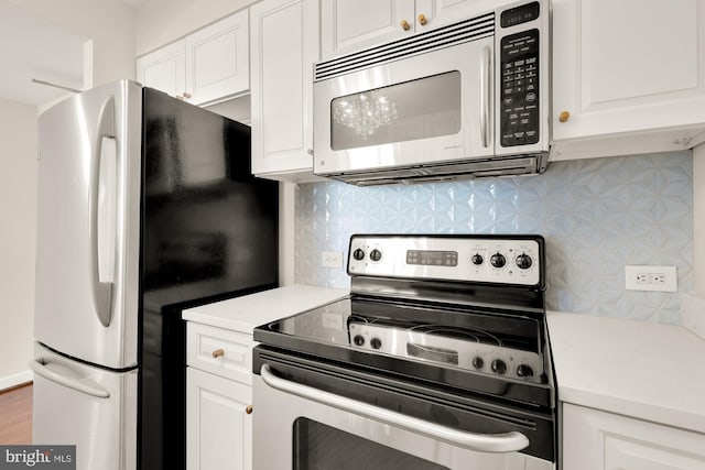 kitchen featuring backsplash, white cabinets, and appliances with stainless steel finishes