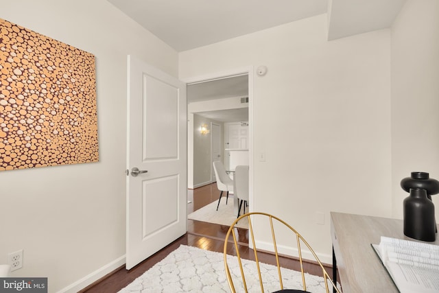 bedroom with dark wood-type flooring