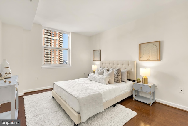 bedroom with dark wood-type flooring