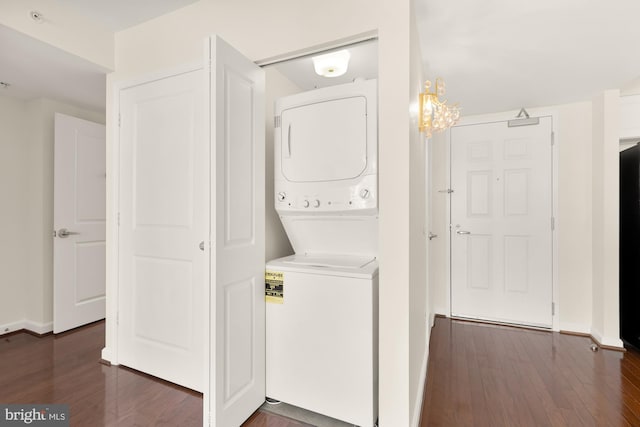 laundry room with stacked washer / dryer and dark hardwood / wood-style flooring