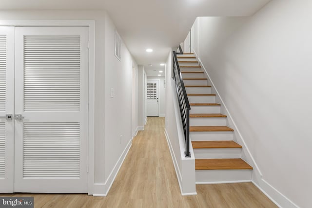 stairs featuring hardwood / wood-style floors