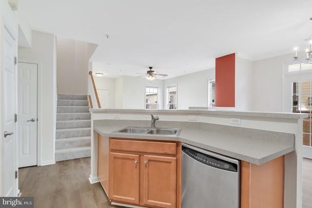 kitchen with sink, stainless steel dishwasher, an island with sink, and light wood-type flooring