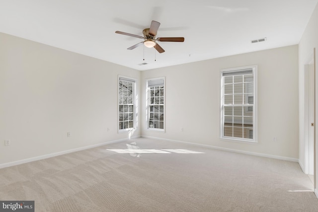 unfurnished room with ceiling fan and light colored carpet