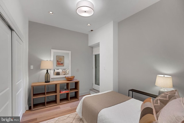 bedroom with a closet and light hardwood / wood-style floors