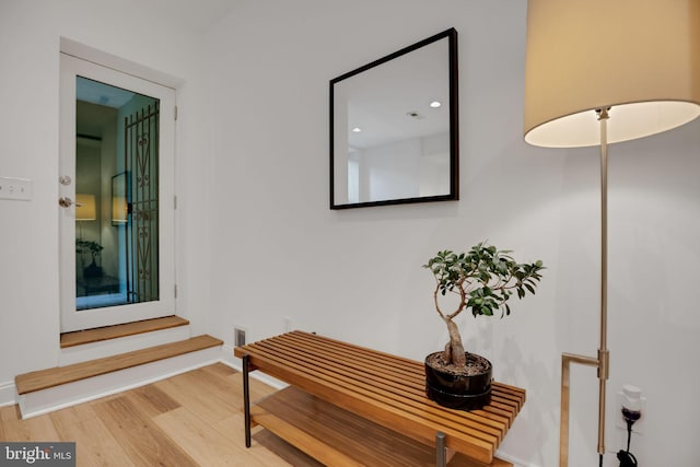 corridor with light hardwood / wood-style floors