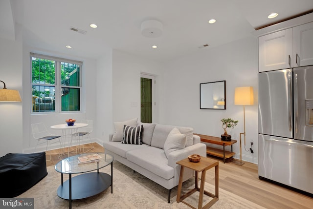 living room with light hardwood / wood-style flooring