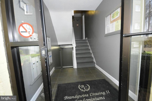 entryway featuring dark tile patterned flooring