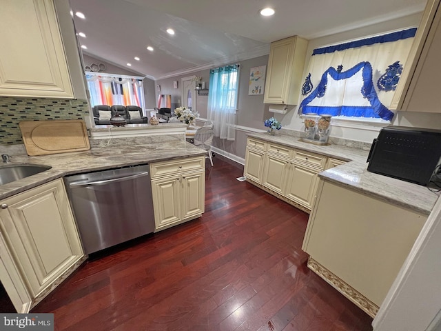 kitchen featuring light stone countertops, dark hardwood / wood-style flooring, stainless steel dishwasher, cream cabinets, and vaulted ceiling