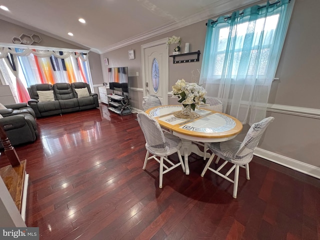 dining area with dark hardwood / wood-style flooring, vaulted ceiling, and crown molding