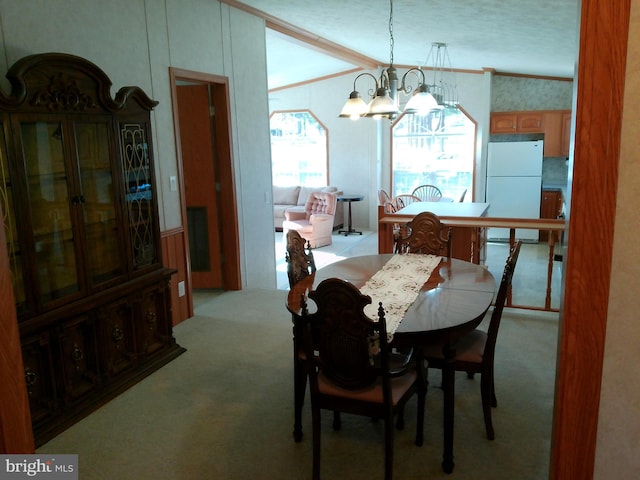 dining room with vaulted ceiling, light colored carpet, a textured ceiling, and a chandelier