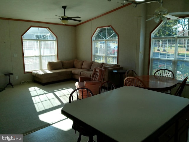 dining room featuring ceiling fan, lofted ceiling, and ornamental molding