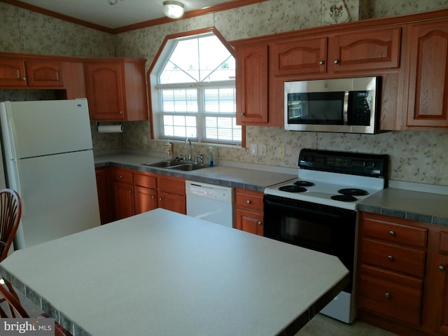 kitchen with white appliances, ornamental molding, and sink