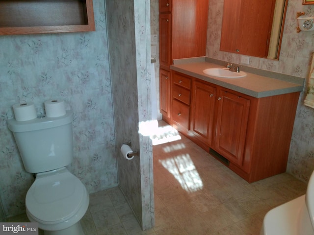 bathroom featuring vanity and toilet