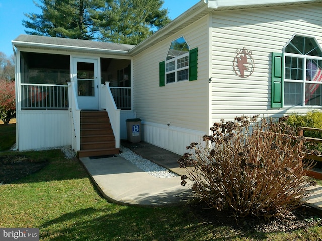 entrance to property featuring a yard