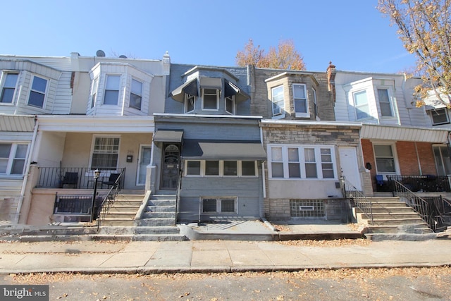 townhome / multi-family property featuring covered porch