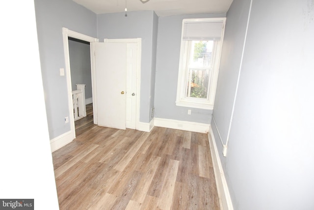 unfurnished bedroom with light wood-type flooring