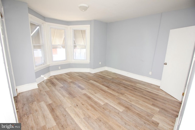 spare room with light wood-type flooring