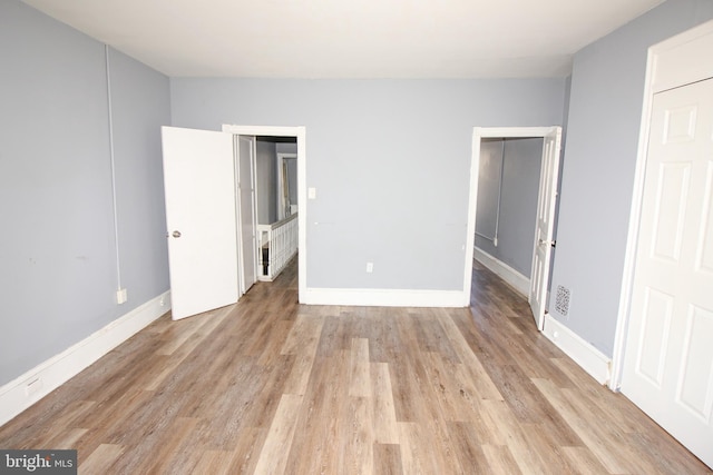 unfurnished bedroom with light wood-type flooring