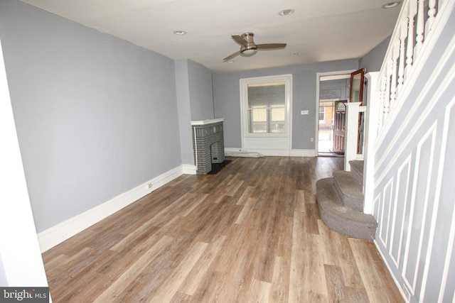 unfurnished living room with ceiling fan and light wood-type flooring