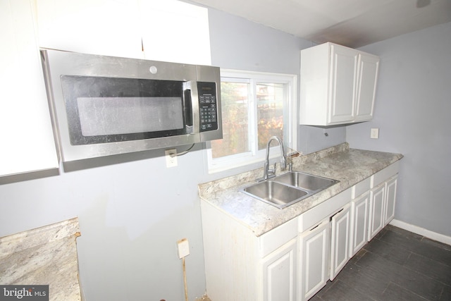 kitchen featuring sink, white cabinets, and lofted ceiling