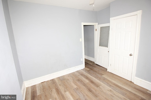 unfurnished bedroom with light hardwood / wood-style flooring and ceiling fan