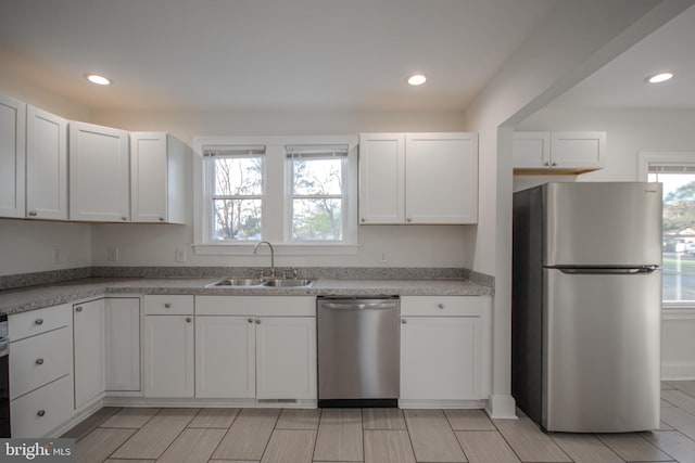 kitchen featuring white cabinetry, sink, and stainless steel appliances