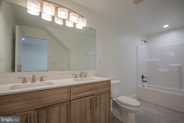 full bathroom featuring shower / tub combination, vanity, hardwood / wood-style flooring, and toilet