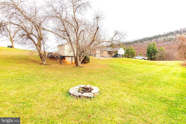 view of yard with an outdoor fire pit