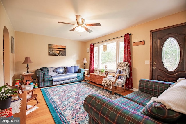 living room featuring ceiling fan and wood-type flooring