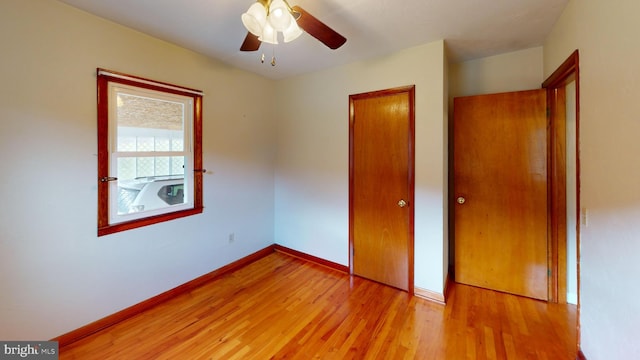 unfurnished bedroom featuring ceiling fan and light hardwood / wood-style floors