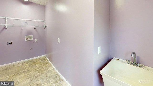 washroom featuring hookup for an electric dryer, sink, and hookup for a washing machine