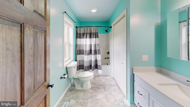 full bathroom featuring vanity, toilet, and shower / tub combo