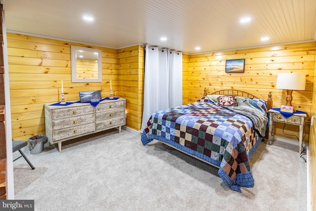 carpeted bedroom with wooden walls