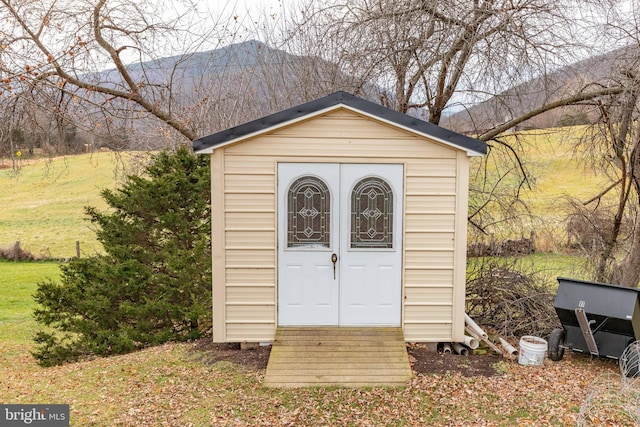 view of outdoor structure featuring a lawn