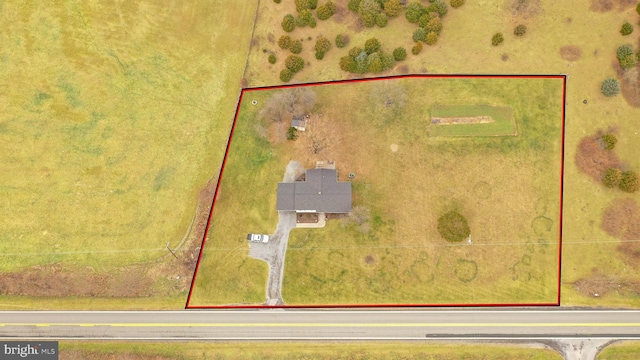 birds eye view of property with a rural view