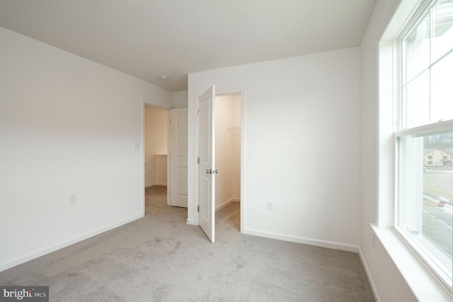 1002 Jacks Pl, Harrisburg, PA 17112 - unfurnished bedroom featuring carpet floors, a spacious closet, and baseboards
