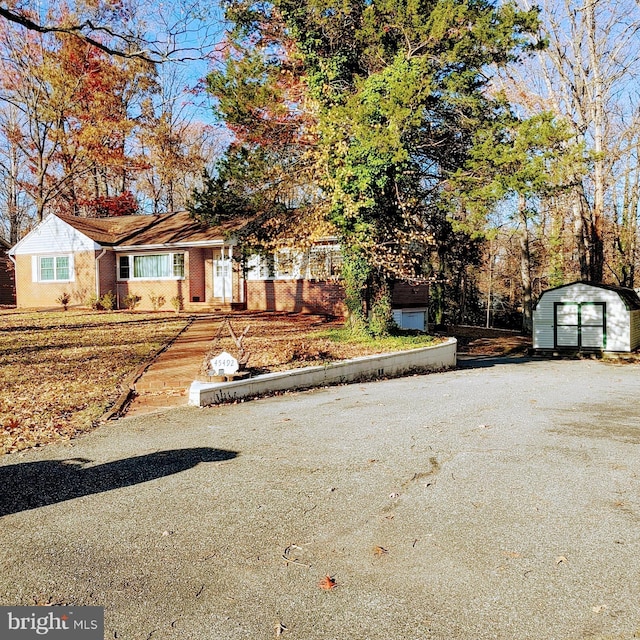 view of front of house with a storage shed