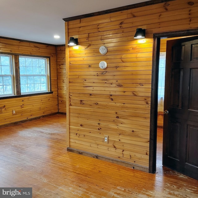 interior space featuring wooden walls and light wood-type flooring